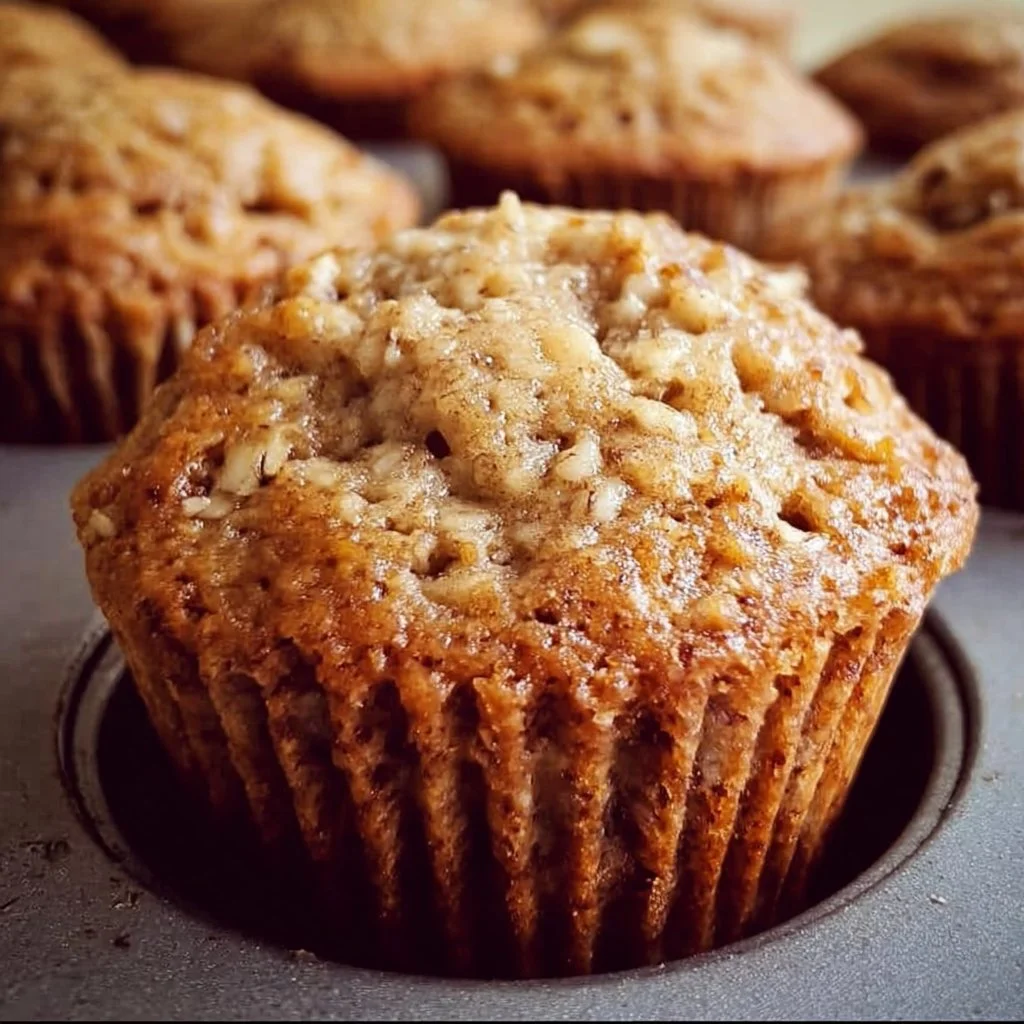 Freshly baked banana oatmeal muffins on a wooden table
